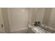 Bathroom showcasing tub with subway tile surround, patterned floors, and marble-top vanity with granite sink at 2085 Dellwood Pl, Decatur, GA 30032