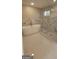 Luxurious bathroom featuring a freestanding tub, glass-enclosed shower, and marble-look tile at 2085 Dellwood Pl, Decatur, GA 30032