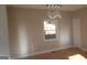 Bedroom with a contemporary light fixture, a window letting in natural light, and hardwood floors at 2085 Dellwood Pl, Decatur, GA 30032