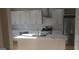 Bright kitchen featuring stainless steel appliances, mosaic tile backsplash, and stylish cabinets with granite countertops at 2085 Dellwood Pl, Decatur, GA 30032