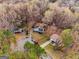 Aerial view of a home with lush trees surrounding the property in a quiet neighborhood with other homes nearby at 3747 Junior Ln, Douglasville, GA 30135