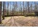 A spacious, fenced backyard featuring mature trees and ample space for outdoor activities and entertaining at 3747 Junior Ln, Douglasville, GA 30135