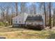 Charming exterior elevation of a two-story home with a low-profile deck and wooded surroundings at 3747 Junior Ln, Douglasville, GA 30135
