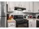 Functional kitchen featuring modern black gas range and oven, along with white cabinetry at 3747 Junior Ln, Douglasville, GA 30135