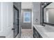 Stylish bathroom with a black framed glass shower and patterned tile flooring at 305 Worthing Ln, Mcdonough, GA 30253