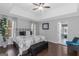 Spacious main bedroom with trey ceiling, large windows, and elegant decor with dark hardwood floors at 305 Worthing Lane, Mcdonough, GA 30253