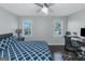 Bright bedroom with two windows, fan, desk, and a modern bed frame at 305 Worthing Ln, Mcdonough, GA 30253