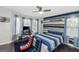 Comfortable bedroom with desk, windows, and blue striped bedding at 305 Worthing Lane, Mcdonough, GA 30253