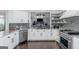 Well-lit kitchen featuring stainless steel appliances, white cabinets, and an eye-catching backsplash design at 305 Worthing Lane, Mcdonough, GA 30253