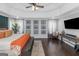 Sun-filled main bedroom featuring a tray ceiling, hardwood floors, and lots of natural light at 305 Worthing Ln, Mcdonough, GA 30253