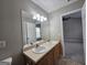 Double vanity bathroom with a large mirror and neutral finishes at 102 Ellis Dr, Conyers, GA 30012