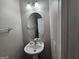 A simple bathroom with a pedestal sink and a large oval mirror at 102 Ellis Dr, Conyers, GA 30012