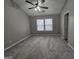 Bright bedroom with neutral walls, carpet flooring, ceiling fan, and a large window at 102 Ellis Dr, Conyers, GA 30012