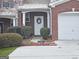 Close-up of the front door with a decorative wreath and landscaped garden bed at 102 Ellis Dr, Conyers, GA 30012
