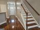 Inviting entryway featuring hardwood floors, a staircase, and a white front door at 102 Ellis Dr, Conyers, GA 30012