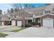 View of the townhome exteriors, showcasing their cohesive design and attached garages at 102 Ellis Dr, Conyers, GA 30012