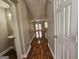 Hallway featuring hardwood floors leading to the living room with access to a half bathroom at 102 Ellis Dr, Conyers, GA 30012