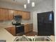 Bright kitchen with stainless steel appliances, wooden cabinets, and modern backsplash at 102 Ellis Dr, Conyers, GA 30012