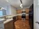 Spacious kitchen with stainless steel appliances, wooden cabinets, and modern lighting fixtures at 102 Ellis Dr, Conyers, GA 30012