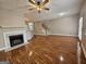 Spacious living room with hardwood floors, a fireplace, and staircase access at 102 Ellis Dr, Conyers, GA 30012