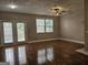 Open living room featuring hardwood floors, a ceiling fan, natural light, and access to the outdoors at 102 Ellis Dr, Conyers, GA 30012
