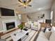 Staged living room featuring a fireplace, ceiling fan, and modern furnishings at 102 Ellis Dr, Conyers, GA 30012
