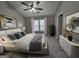 Cozy staged bedroom with a queen sized bed, soft lighting, and bright window views at 102 Ellis Dr, Conyers, GA 30012