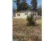 A cozy single-story house with white siding, black roof, and yellow awning accents at 3100 Bay St, Scottdale, GA 30079