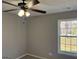 Bedroom featuring neutral walls, a window and a ceiling fan at 328 Cattlemans Cir, Mcdonough, GA 30252