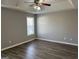 Bright bedroom with tray ceilings, a ceiling fan, and hardwood flooring at 328 Cattlemans Cir, Mcdonough, GA 30252