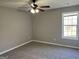 This carpeted bedroom features a window with a view and a ceiling fan for added comfort at 328 Cattlemans Cir, Mcdonough, GA 30252