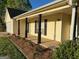 Charming exterior of a home with yellow siding and black shutters and columns at 328 Cattlemans Cir, Mcdonough, GA 30252