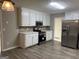Bright kitchen with stainless steel appliances, white cabinets and a hardwood floor at 328 Cattlemans Cir, Mcdonough, GA 30252