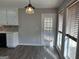 Eat-in kitchen featuring natural light, white cabinets and hardwood floors at 328 Cattlemans Cir, Mcdonough, GA 30252