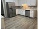 Well-lit kitchen features white cabinets, stone countertops, and stainless steel appliances at 328 Cattlemans Cir, Mcdonough, GA 30252