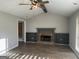 Spacious living room featuring a stone fireplace, built-in shelves and a ceiling fan at 328 Cattlemans Cir, Mcdonough, GA 30252