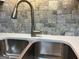 Modern stainless steel kitchen sink with a stylish faucet and tiled backsplash at 328 Cattlemans Cir, Mcdonough, GA 30252