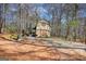 Charming barn-style home with inviting porch and surrounded by mature trees, offering rustic appeal and tranquility at 5642 N Highway 212, Covington, GA 30016