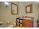 Rustic bathroom with a unique wood vanity, stylish mirror and a neutral color scheme at 5642 N Highway 212, Covington, GA 30016