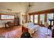 Light-filled living room with a futon, hardwood floors, and large windows at 5642 N Highway 212, Covington, GA 30016