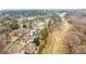 Aerial view of a residential area with golf course and lake, surrounded by lush greenery at 2510 Shoreline Pkwy, Villa Rica, GA 30180