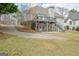 Back of house featuring a spacious deck, lower level patio, and landscaped yard at 2510 Shoreline Pkwy, Villa Rica, GA 30180