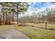 Expansive landscaped backyard with a view of a golf course and mature trees at 2510 Shoreline Pkwy, Villa Rica, GA 30180