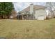 Exterior of the home showcasing a wooden deck with stairs and a well-manicured lawn at 2510 Shoreline Pkwy, Villa Rica, GA 30180