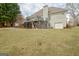 Exterior of the home showcasing a wooden deck with stairs and a well-manicured lawn at 2510 Shoreline Pkwy, Villa Rica, GA 30180