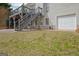 Home exterior featuring a deck with stairs and a ground-level garage at 2510 Shoreline Pkwy, Villa Rica, GA 30180