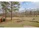 Expansive backyard view showing well manicured lawn and scattered trees on property at 2510 Shoreline Pkwy, Villa Rica, GA 30180