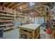 Unfinished basement workshop with workbench and exposed ceiling joists at 2510 Shoreline Pkwy, Villa Rica, GA 30180