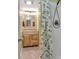 Bathroom with light wood vanity, granite countertop, and shower with floral curtain at 2510 Shoreline Pkwy, Villa Rica, GA 30180