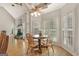 Bright breakfast nook features shuttered windows, hardwood floors, and a breakfast table with seating for four at 2510 Shoreline Pkwy, Villa Rica, GA 30180